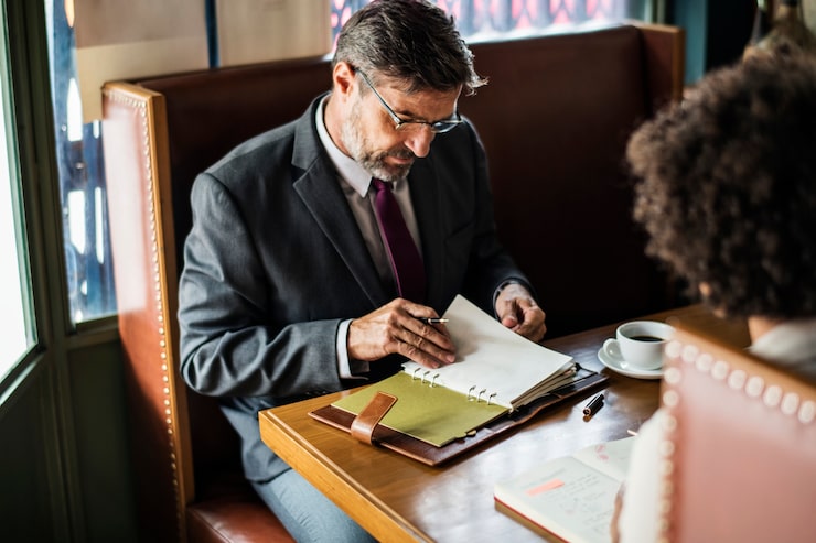 Employment lawyer reviewing legal documents during a client consultation in London